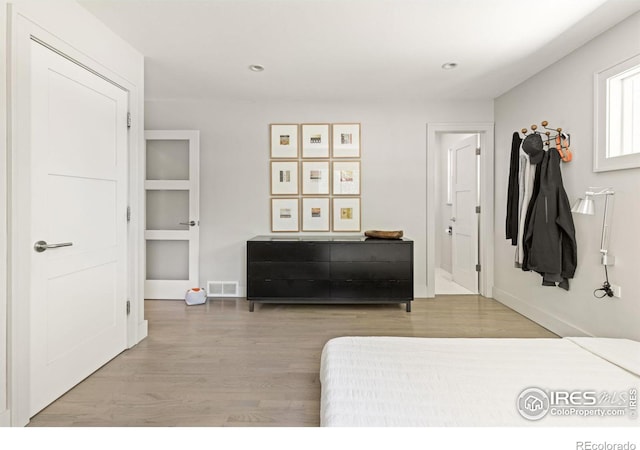 bedroom with hardwood / wood-style floors