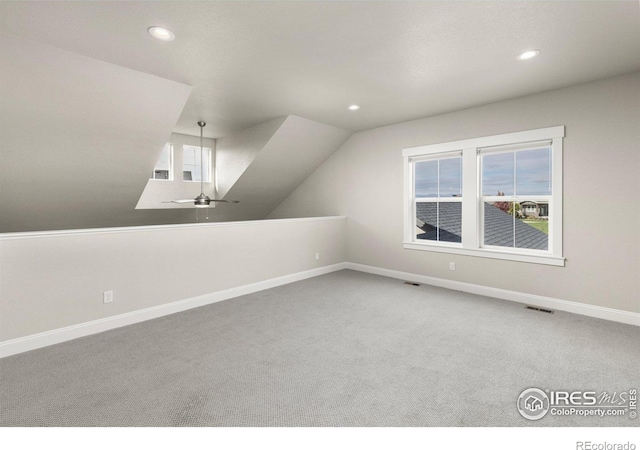 additional living space with carpet floors, vaulted ceiling, and ceiling fan