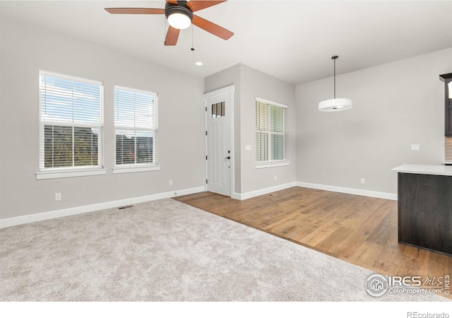 interior space with hardwood / wood-style flooring and ceiling fan