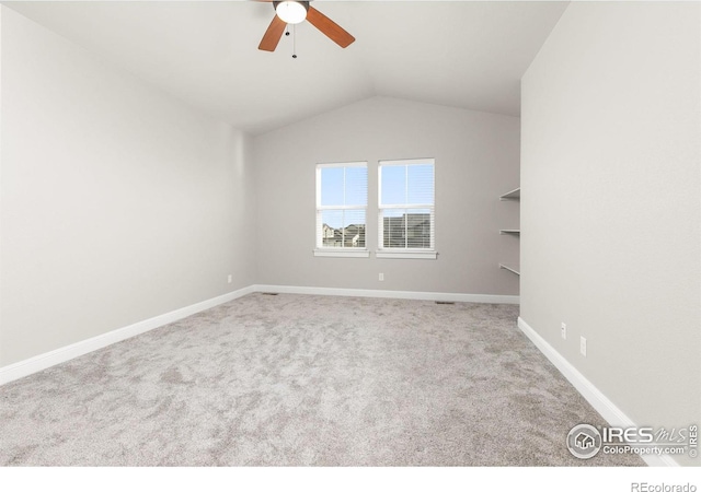 spare room with light carpet, lofted ceiling, and ceiling fan