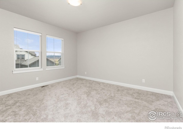 empty room with light colored carpet