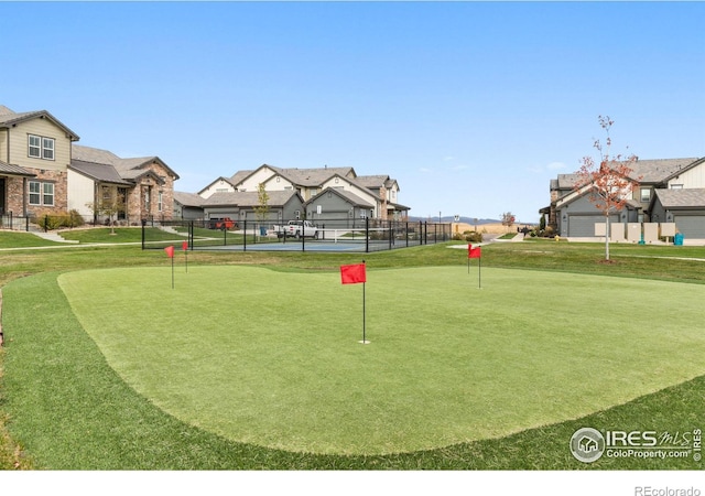 view of home's community with tennis court