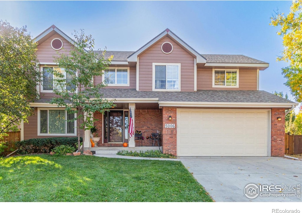 view of front of property featuring a garage and a front lawn