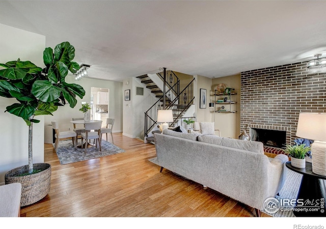 living room with hardwood / wood-style flooring and a fireplace