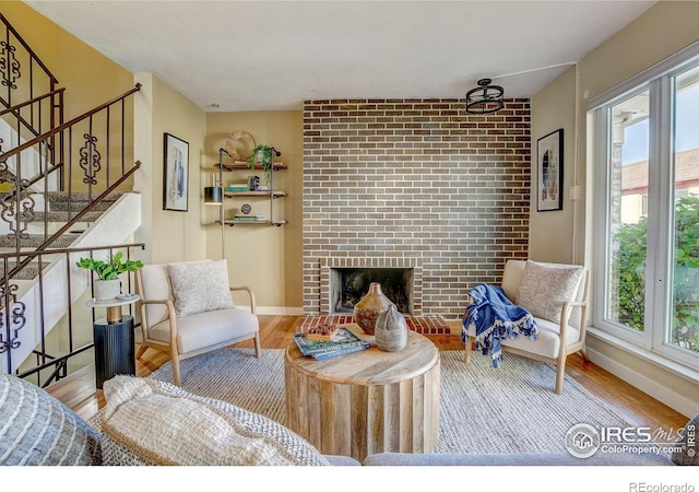 living room with light hardwood / wood-style floors and a fireplace