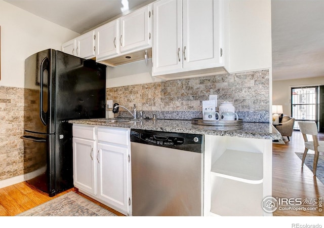 kitchen with dishwasher, white cabinets, light wood-type flooring, and black fridge