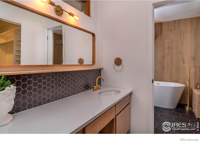 bathroom with vanity, decorative backsplash, and tile patterned floors