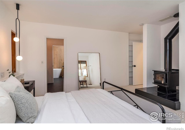 bedroom featuring a wood stove