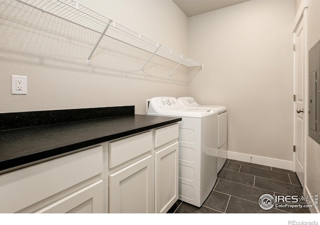 laundry area with dark tile patterned flooring and independent washer and dryer