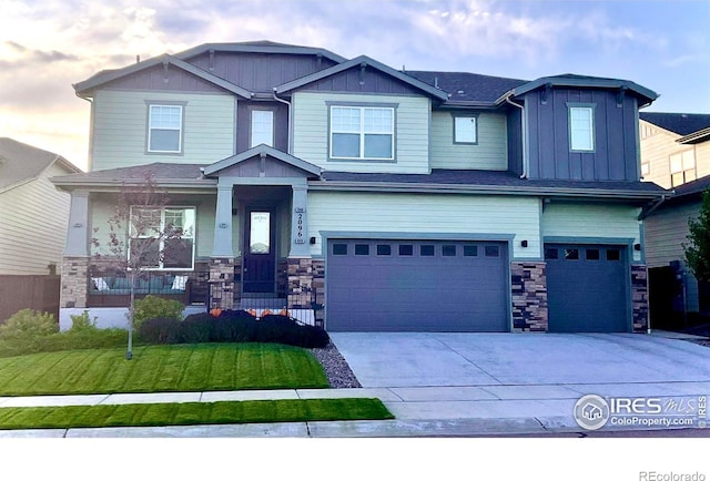 craftsman-style home featuring a yard and a garage