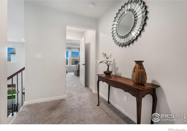 hallway with light colored carpet