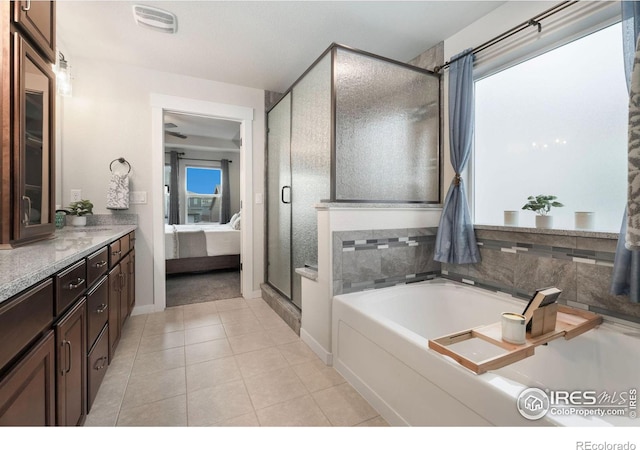 bathroom with vanity, shower with separate bathtub, and tile patterned flooring