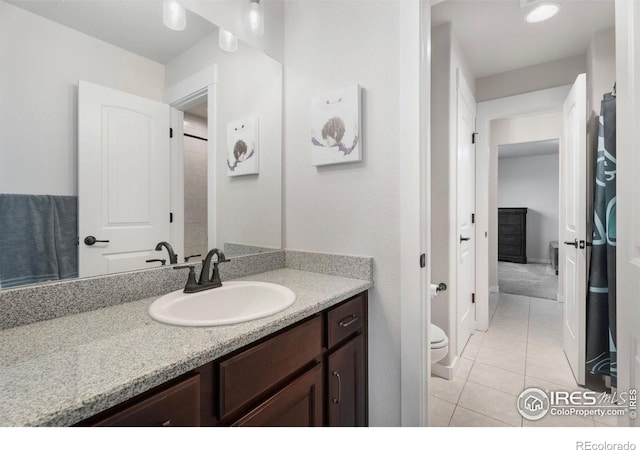 bathroom featuring vanity, toilet, and tile patterned floors