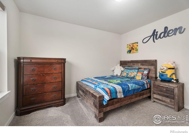 bedroom featuring light colored carpet