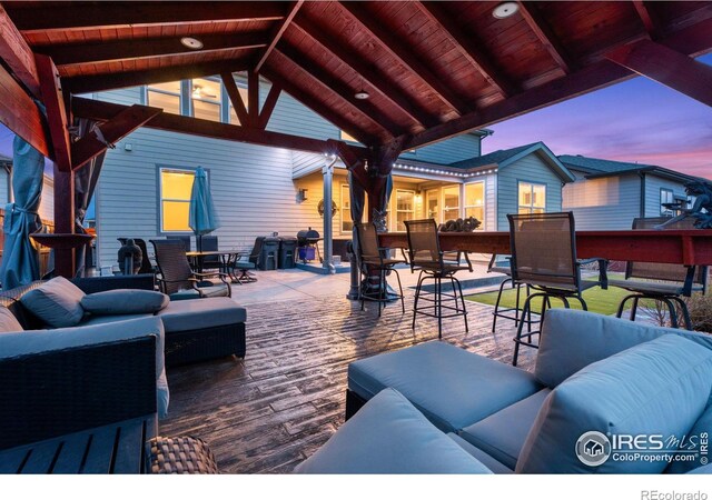 patio terrace at dusk featuring outdoor lounge area