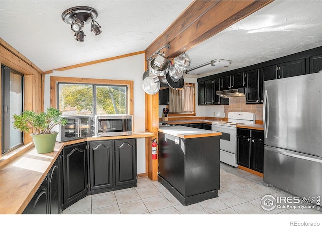 kitchen featuring vaulted ceiling, appliances with stainless steel finishes, light tile patterned floors, a textured ceiling, and decorative backsplash