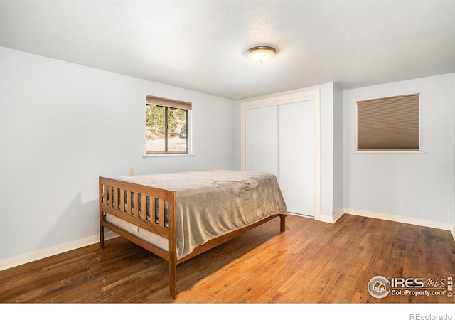 bedroom featuring a closet and hardwood / wood-style flooring