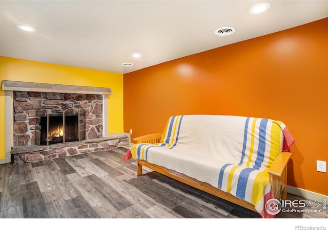 living area featuring a fireplace and wood-type flooring