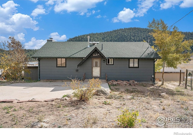 view of front of property with a patio area and a mountain view