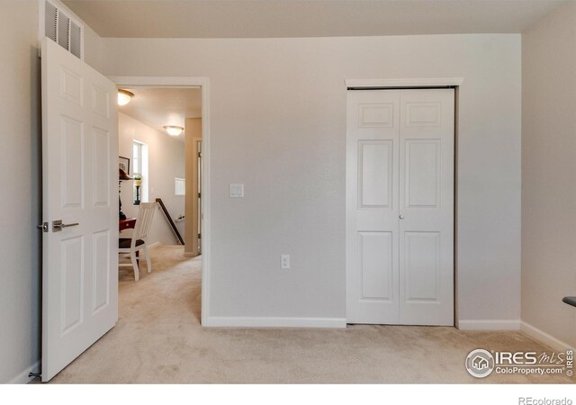 carpeted bedroom featuring a closet