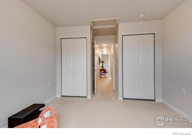 bedroom featuring light carpet and a closet