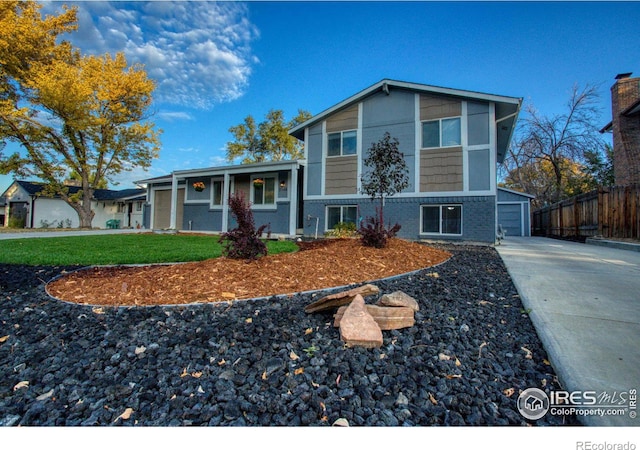 tri-level home with a front yard and a garage