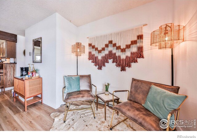 174 Tall Pine Cir Unit 12-C, Grand Lake, CO 80447 - sitting room featuring a textured ceiling and light wood-type flooring