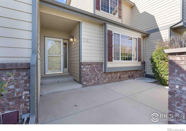 doorway to property with a patio area