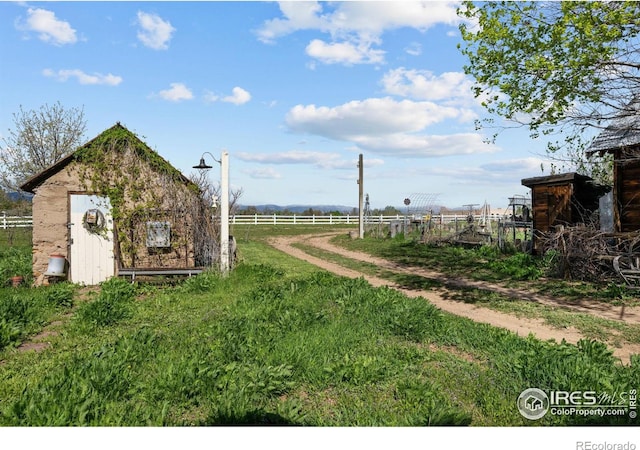 view of yard featuring an outbuilding and a rural view