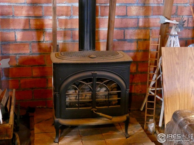 room details with tile patterned floors and a wood stove