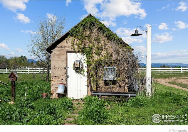 view of outdoor structure with a rural view