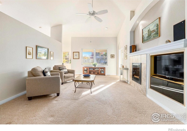 carpeted living room featuring high vaulted ceiling, a fireplace, and ceiling fan