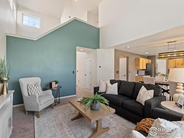 living room featuring a high ceiling and light colored carpet