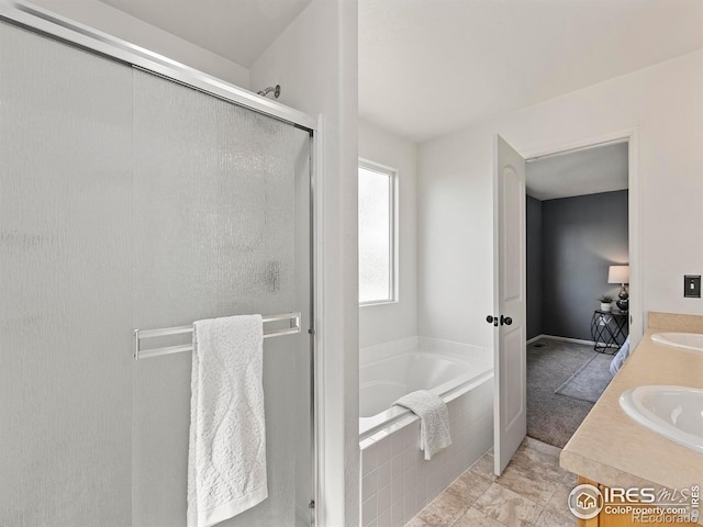 bathroom featuring vanity, shower with separate bathtub, and tile patterned flooring