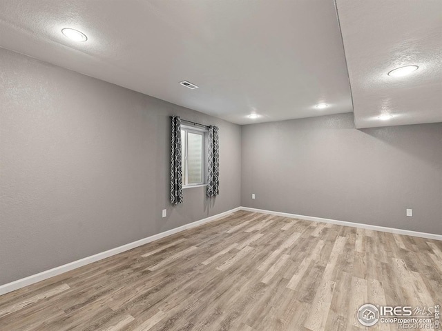 unfurnished room with light hardwood / wood-style flooring