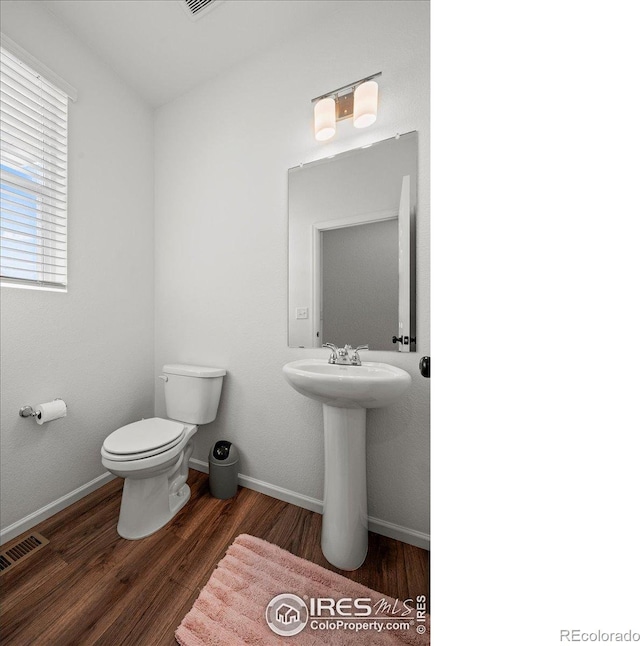 bathroom featuring toilet, sink, and hardwood / wood-style floors