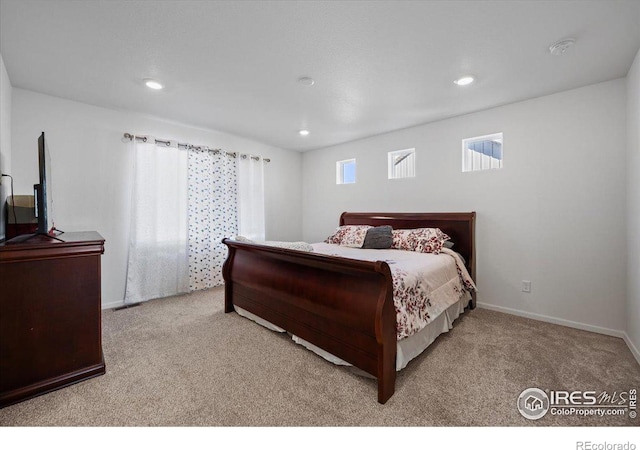 bedroom featuring light carpet and multiple windows