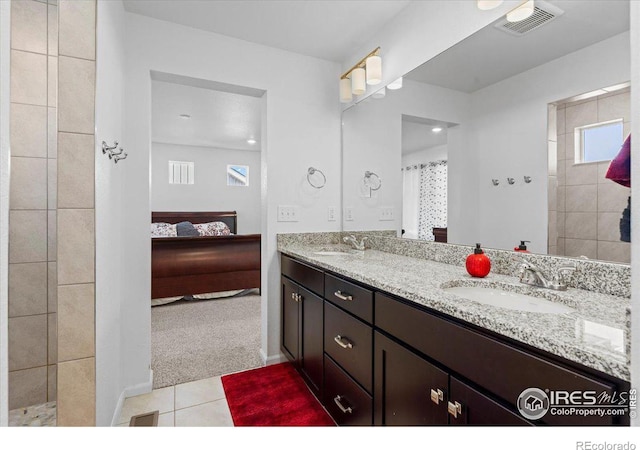 bathroom featuring vanity, walk in shower, and tile patterned floors