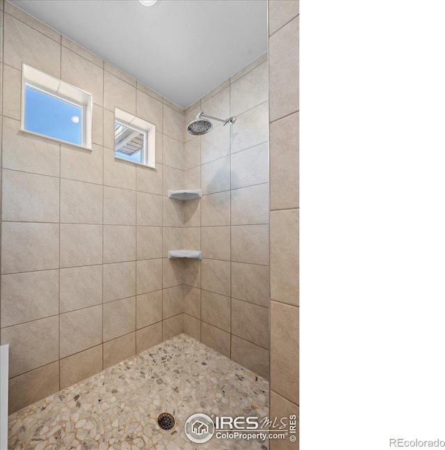 bathroom with tiled shower