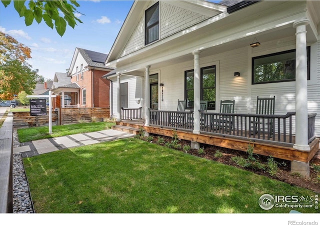 exterior space featuring covered porch and a lawn