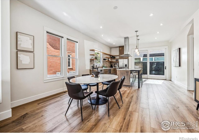 dining space featuring light wood-type flooring