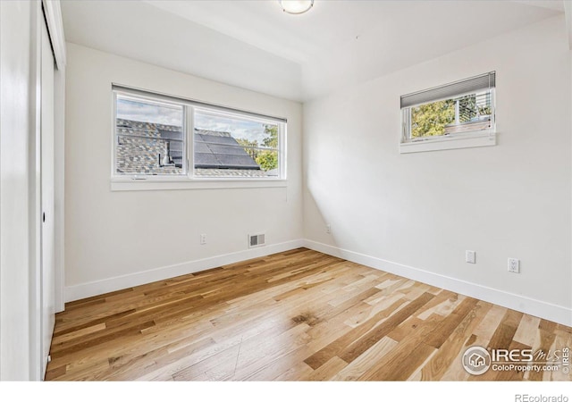 empty room with hardwood / wood-style floors