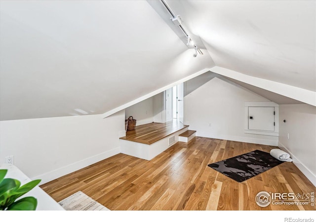 bonus room with light hardwood / wood-style flooring and lofted ceiling