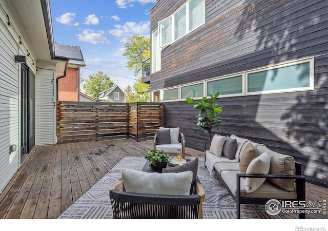 wooden terrace featuring an outdoor living space