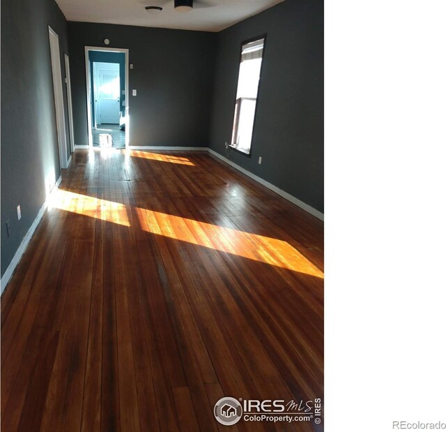 unfurnished room featuring ceiling fan and wood-type flooring