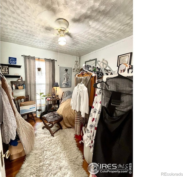 bedroom with ceiling fan and a textured ceiling