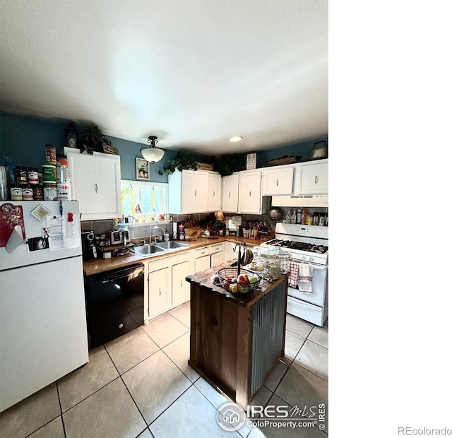 kitchen with white appliances, white cabinets, a kitchen island, sink, and light tile patterned flooring