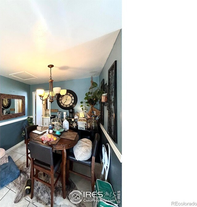 dining room with light tile patterned flooring and a notable chandelier