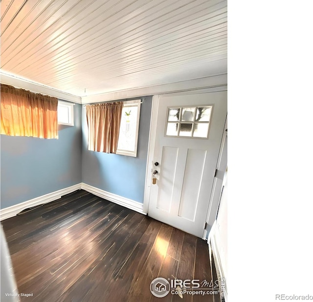 foyer entrance featuring dark wood-style flooring and baseboards
