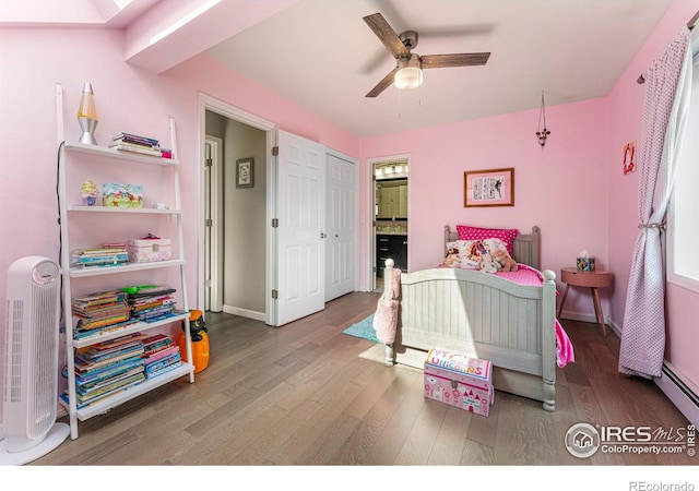 bedroom with hardwood / wood-style flooring, ensuite bath, a skylight, and ceiling fan